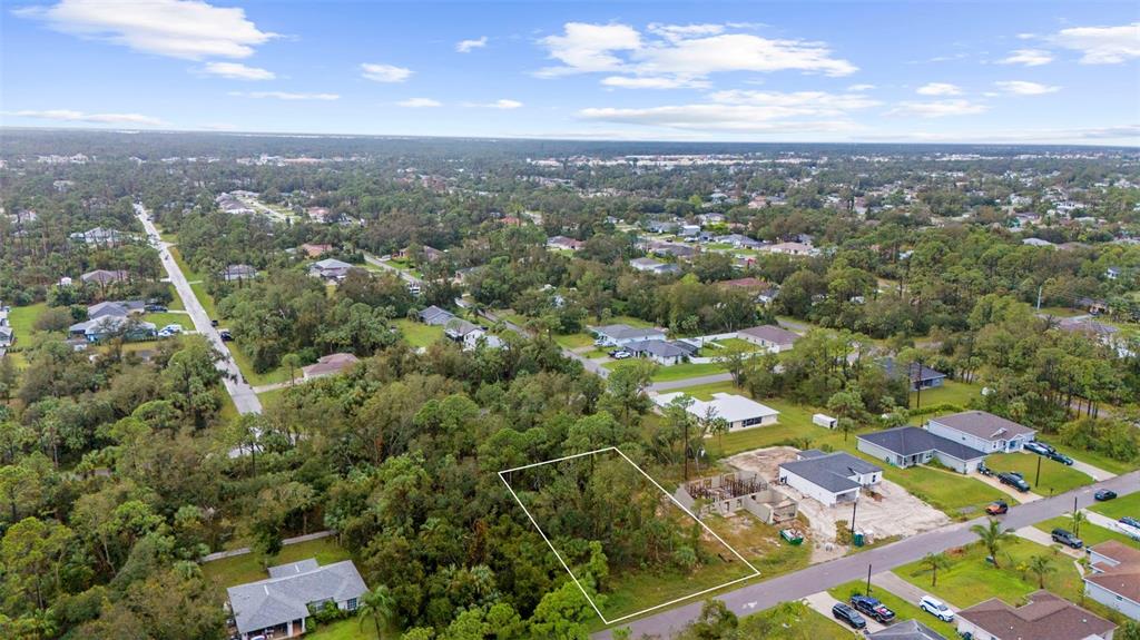 an aerial view of residential houses with city view