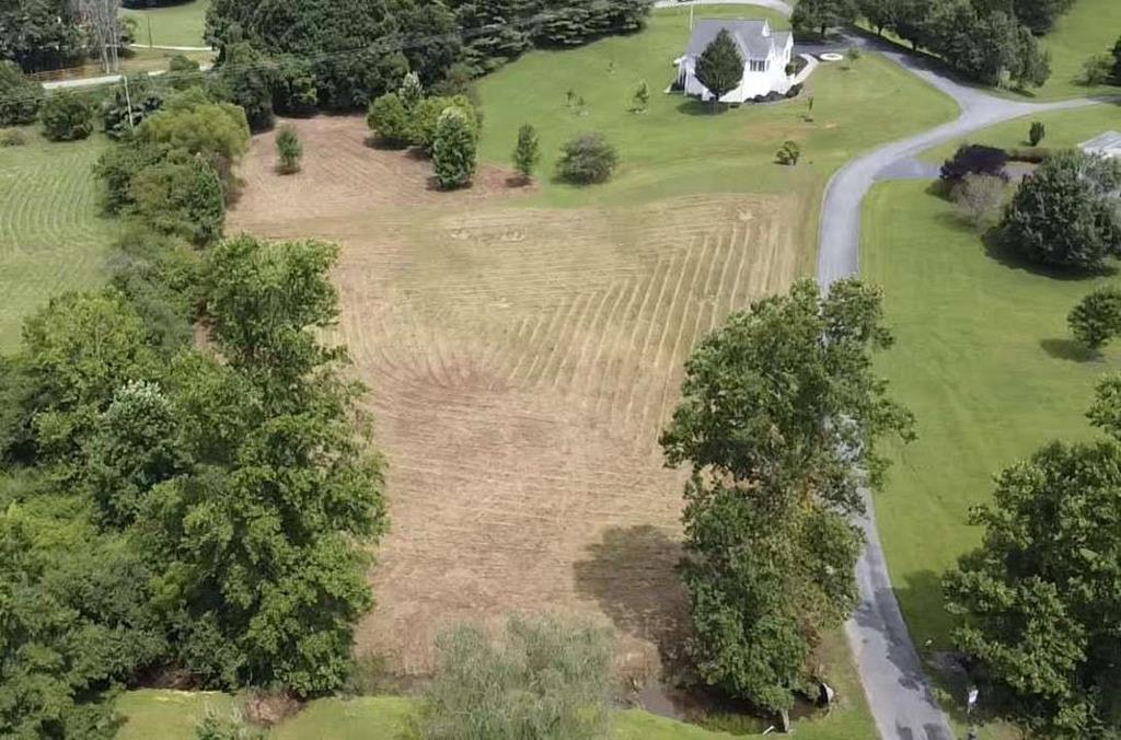 an aerial view of a house with yard