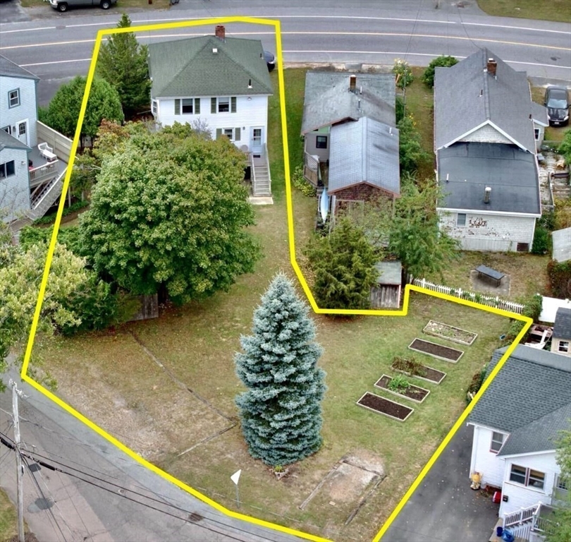 an aerial view of a house with a yard