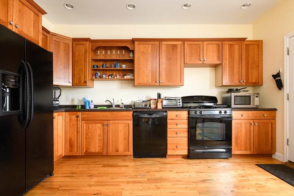 a kitchen with stainless steel appliances granite countertop a refrigerator stove and sink