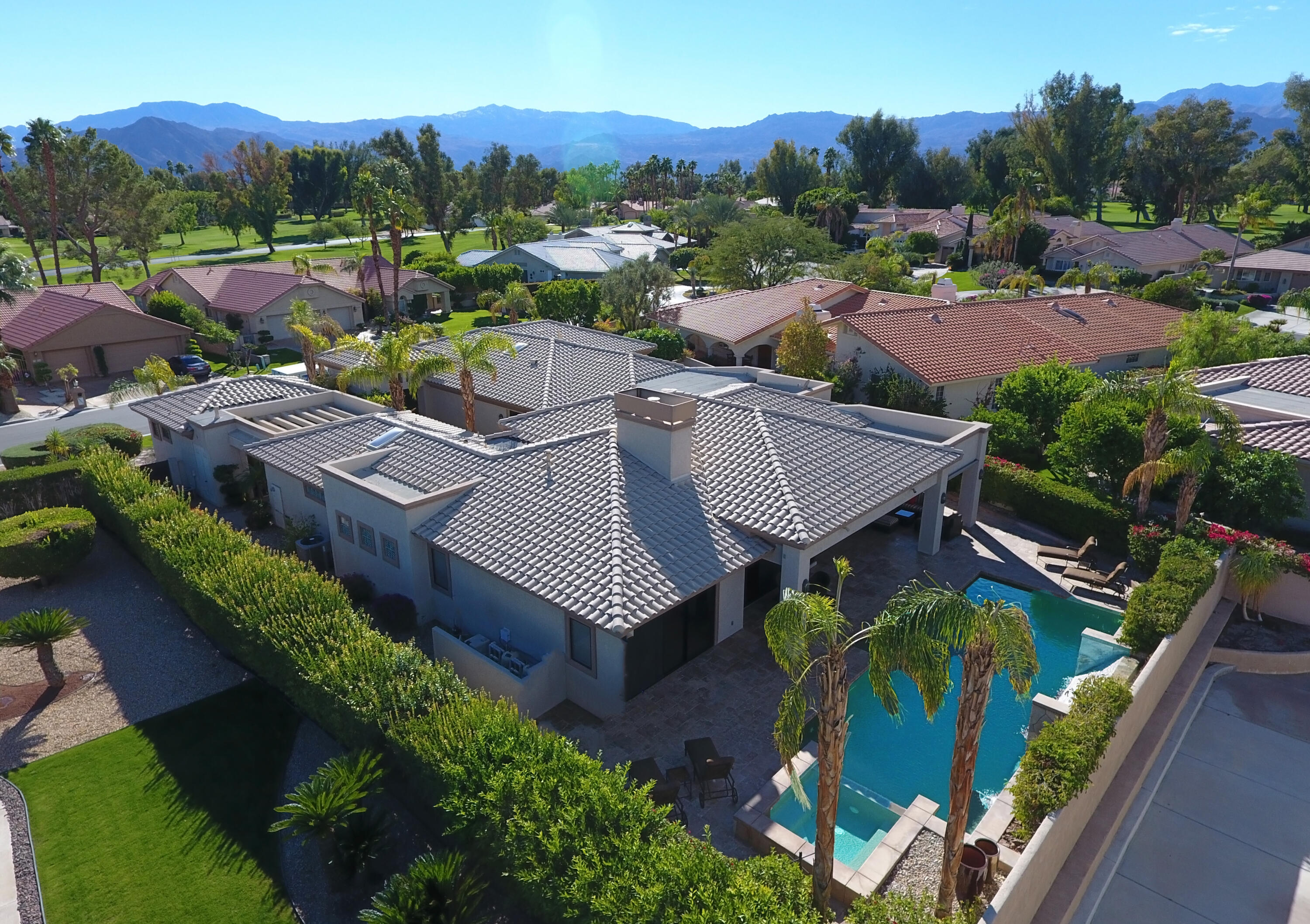 an aerial view of a house with garden space and street view