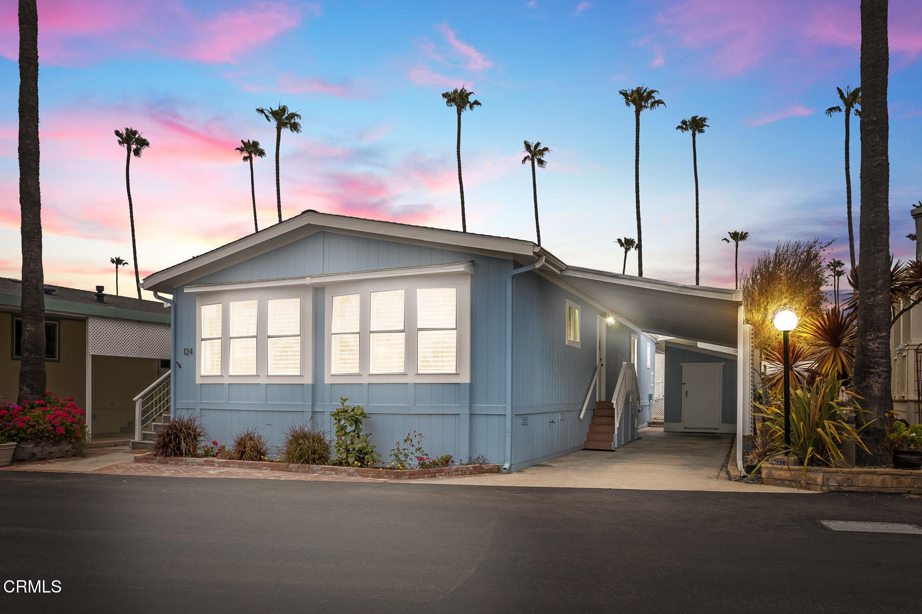 a front view of a house with a street