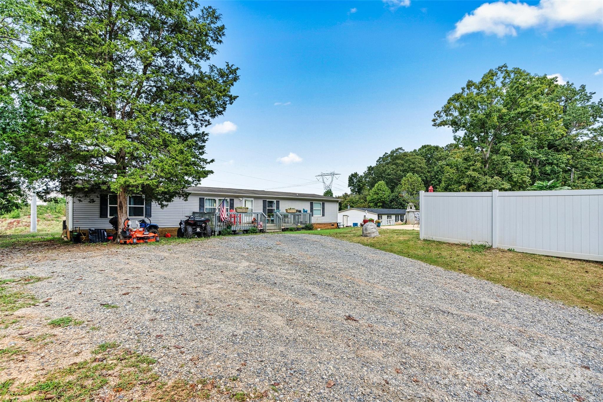 a view of a house with a yard and large trees