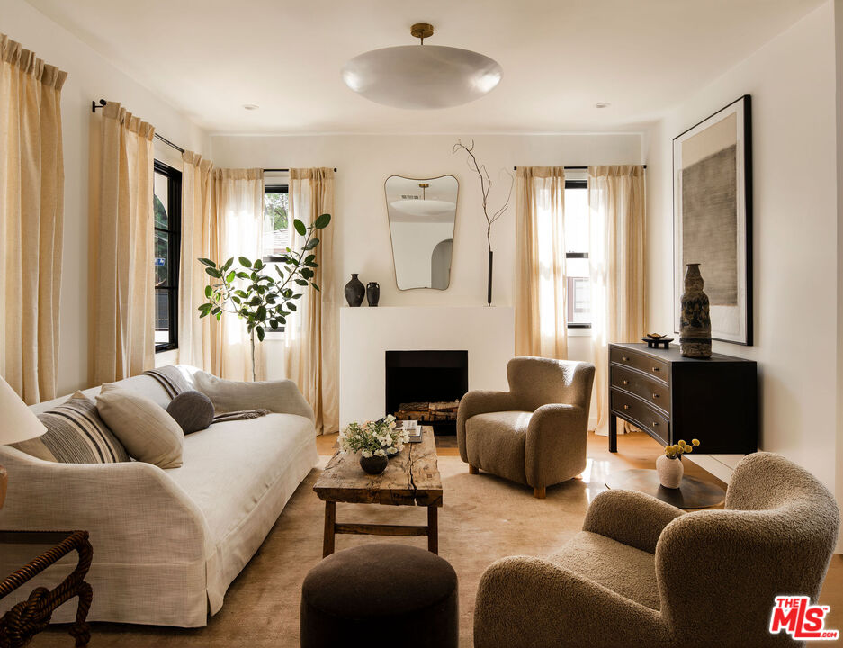 a living room with furniture and a fireplace