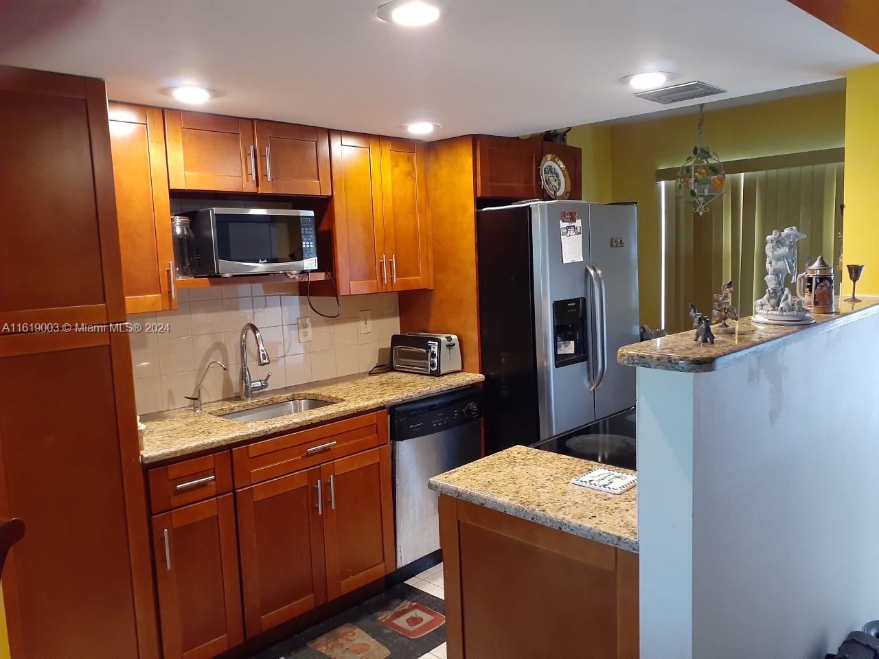 a kitchen with a refrigerator sink and microwave