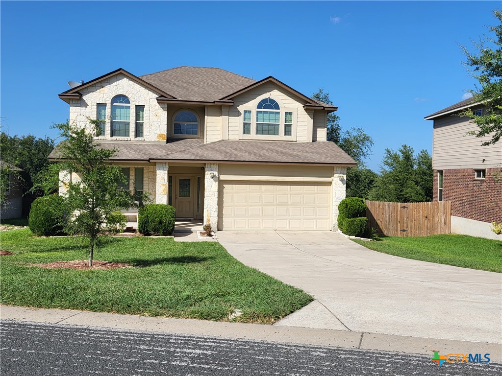 a front view of a house with a yard and garage