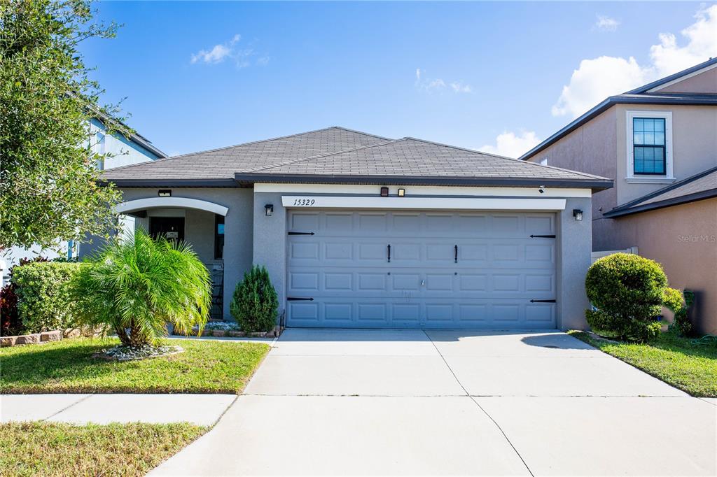 a front view of a house with a yard and garage