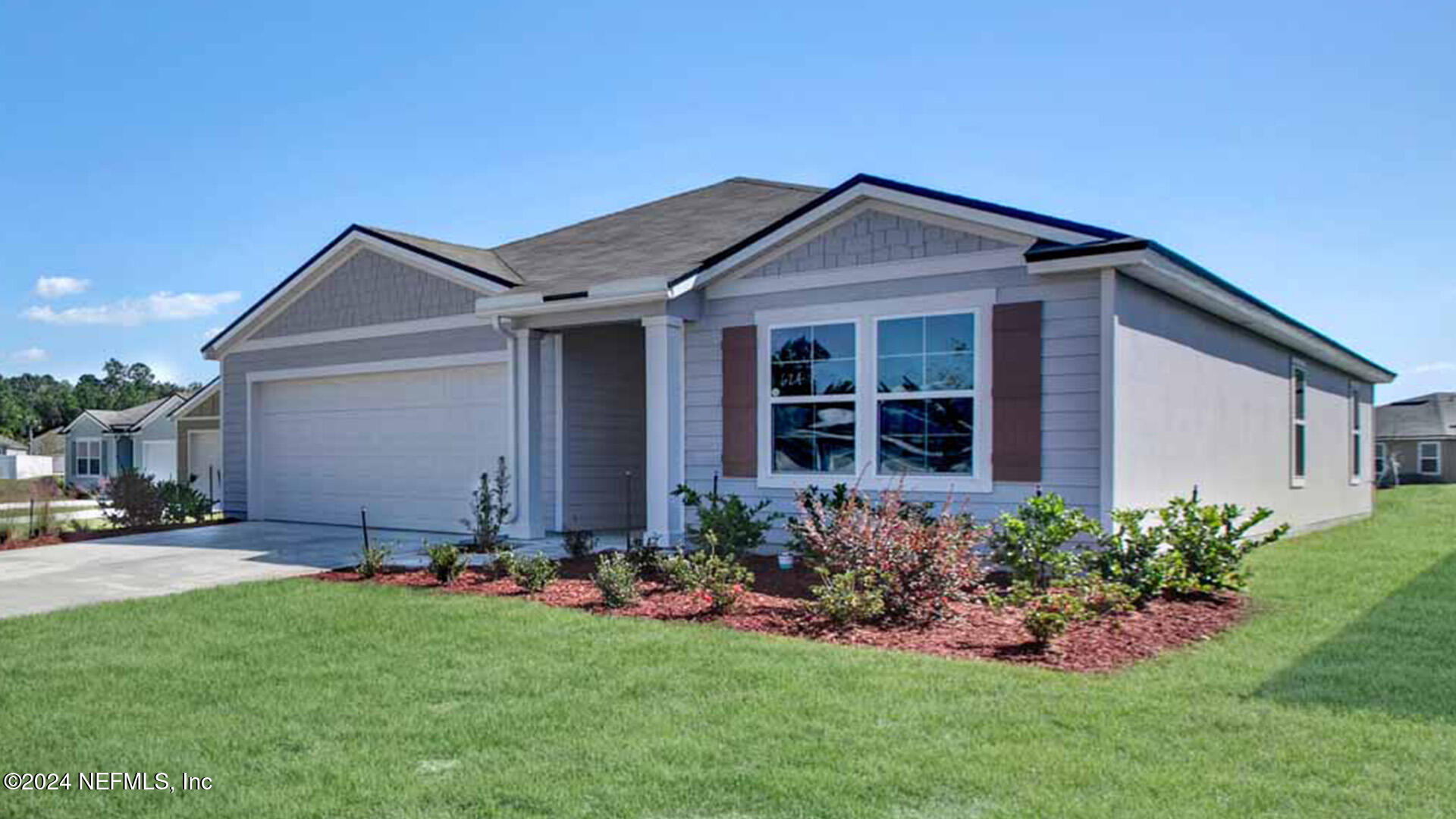 a front view of house with a garden