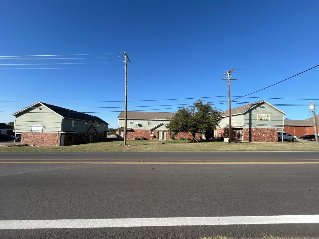 a view of a houses with a big yard and potted plants