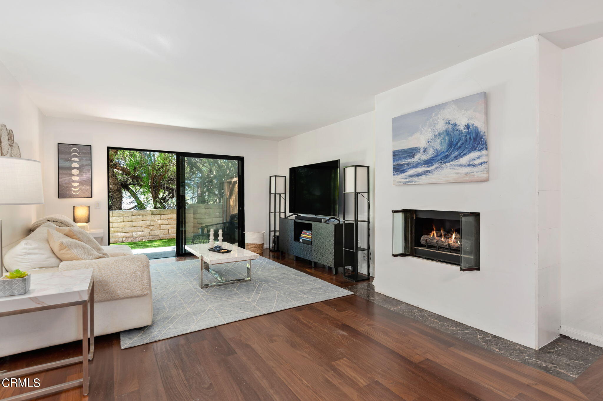 a living room with furniture a fireplace and a flat screen tv