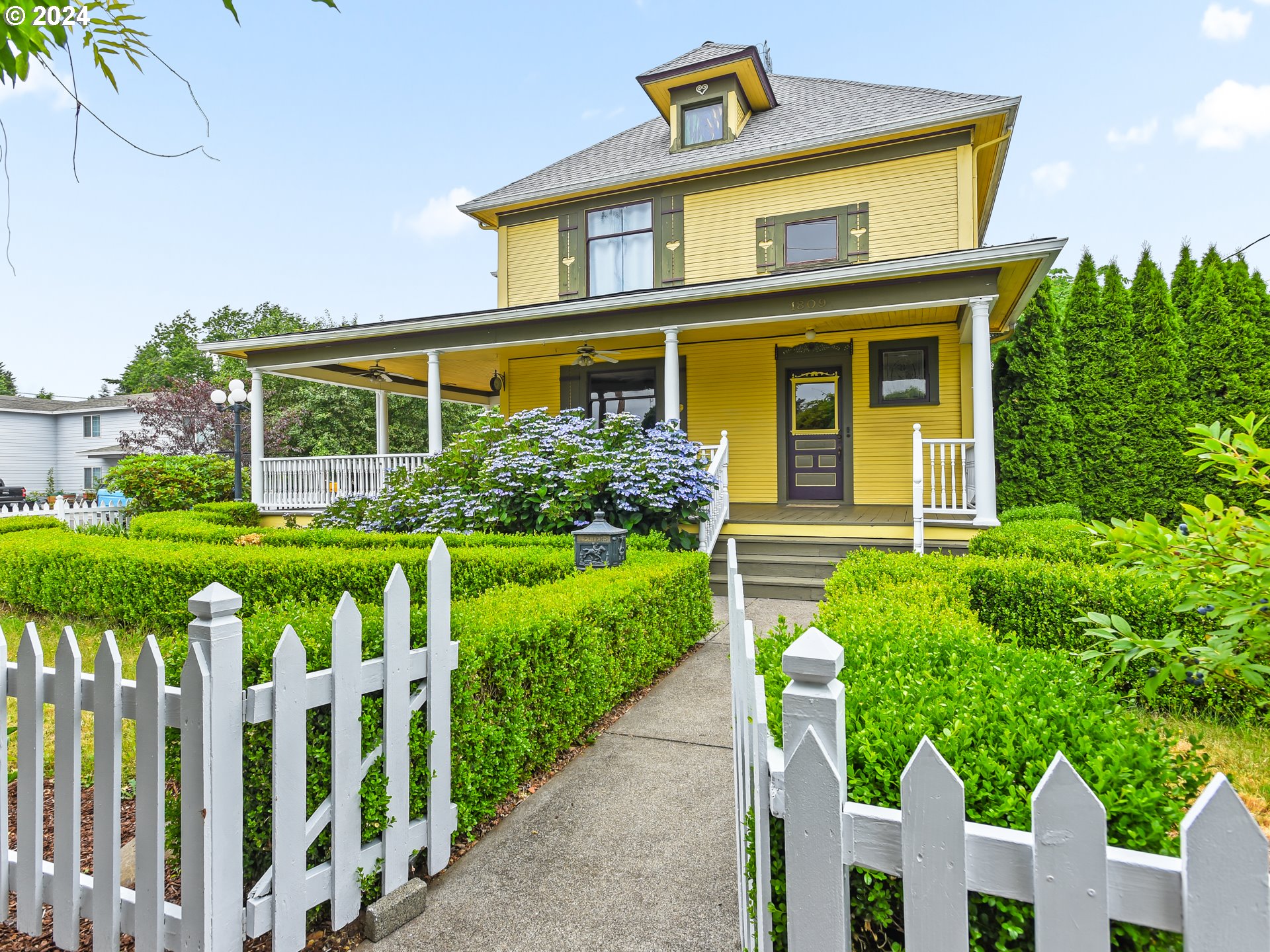 a front view of house with yard and green space