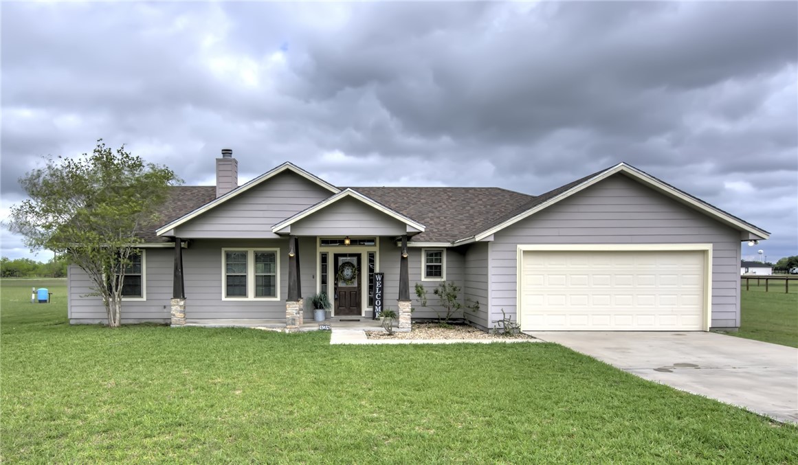 a front view of house with yard and green space