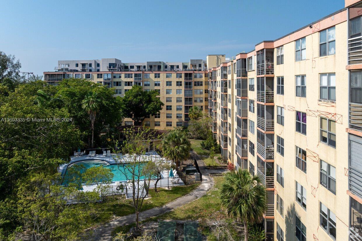 a view of swimming pool with outdoor seating and plants