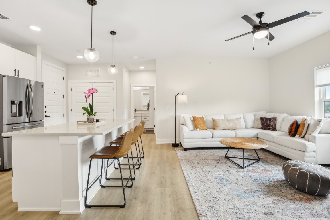 a living room with furniture and kitchen view