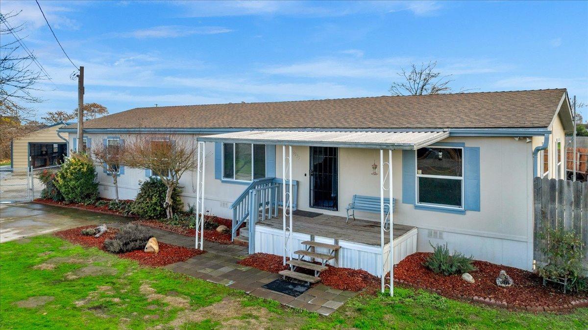 a view of a house with a backyard and porch