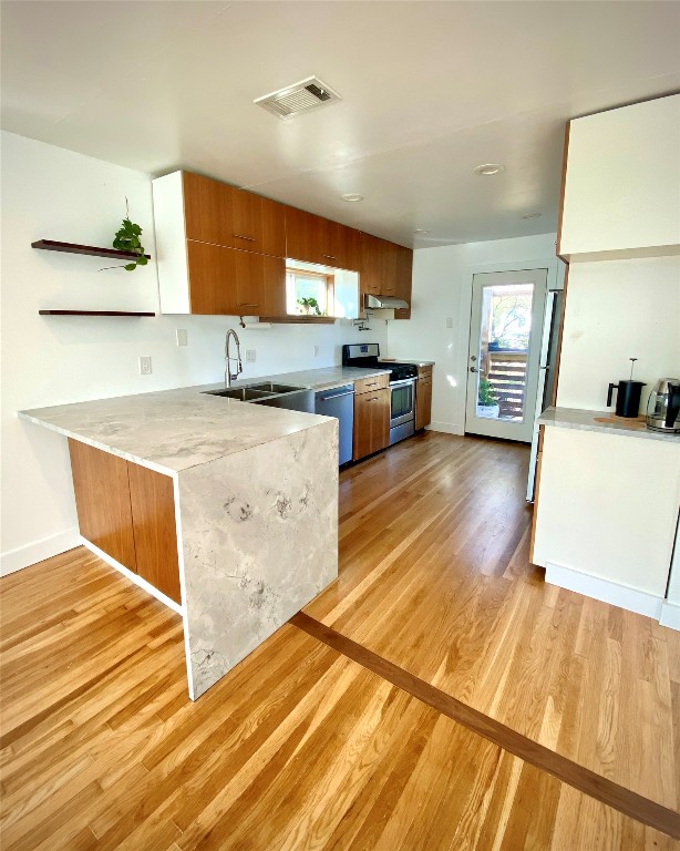 a kitchen with wooden floors and cabinets