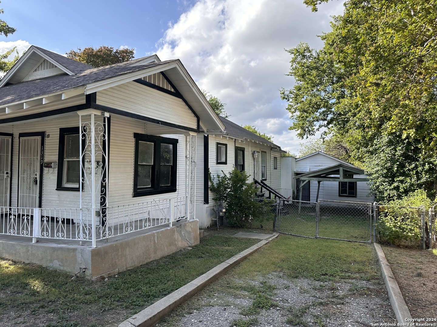 a view of house with a yard and plants