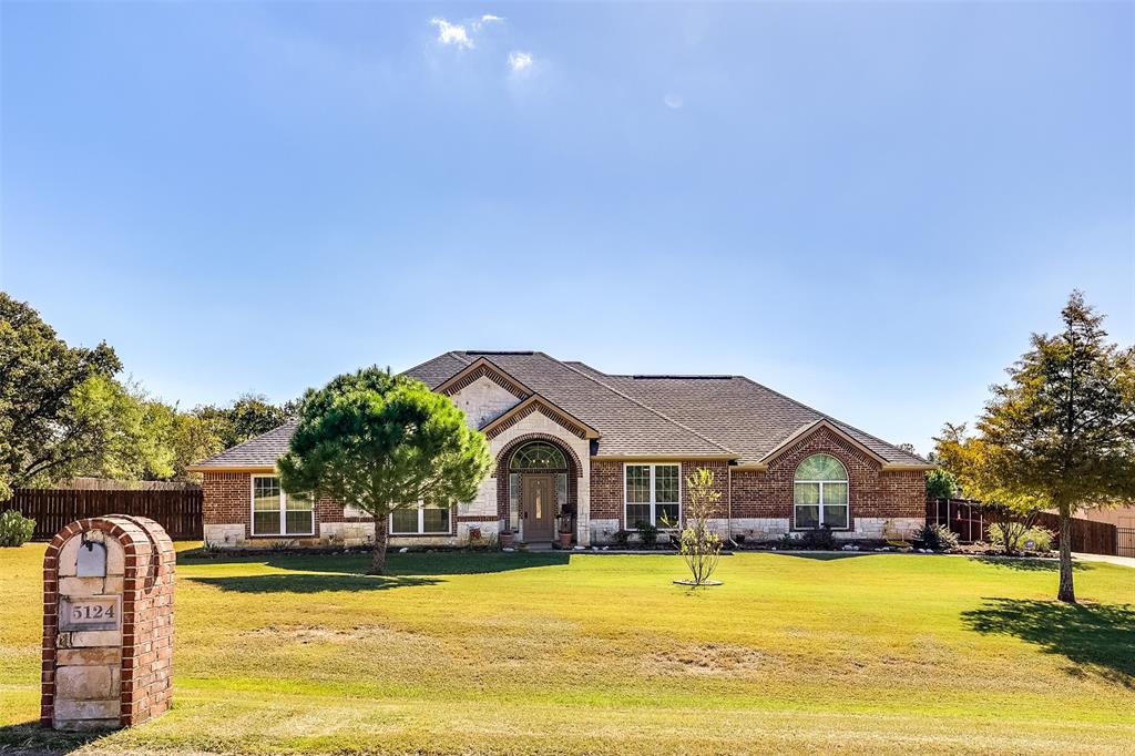 a front view of house with yard and swimming pool