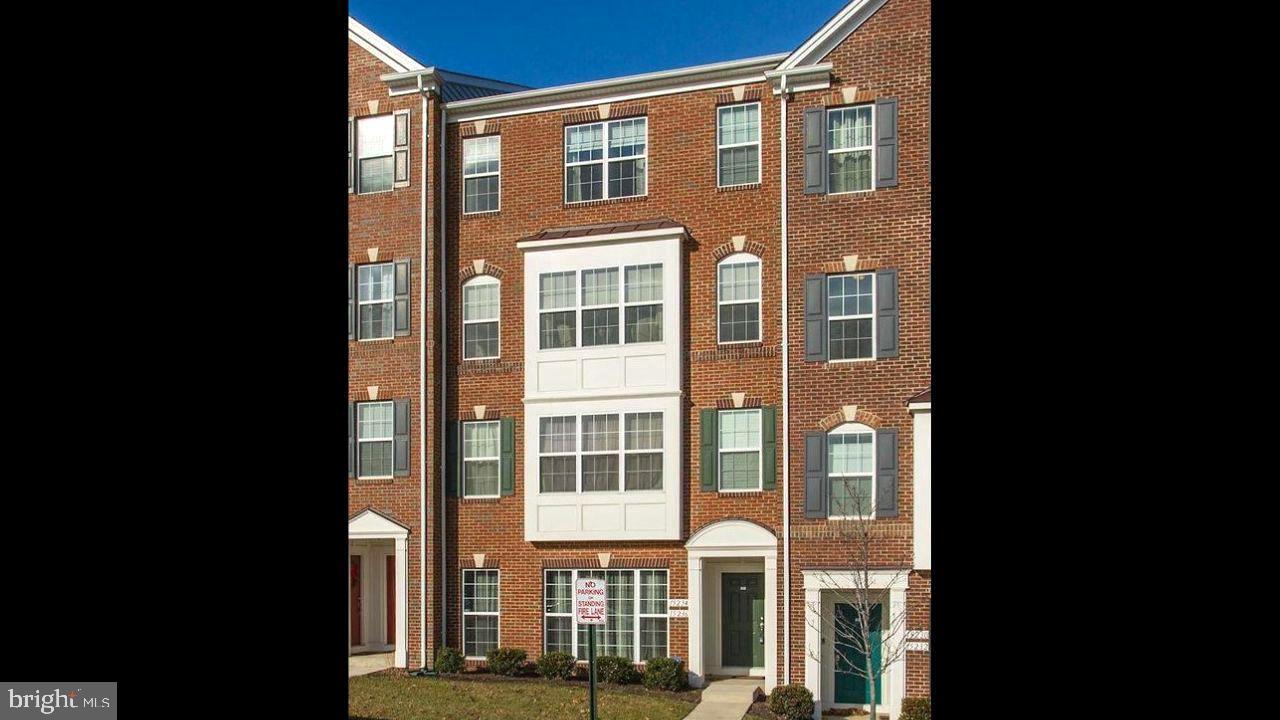 a view of brick building next to a yard