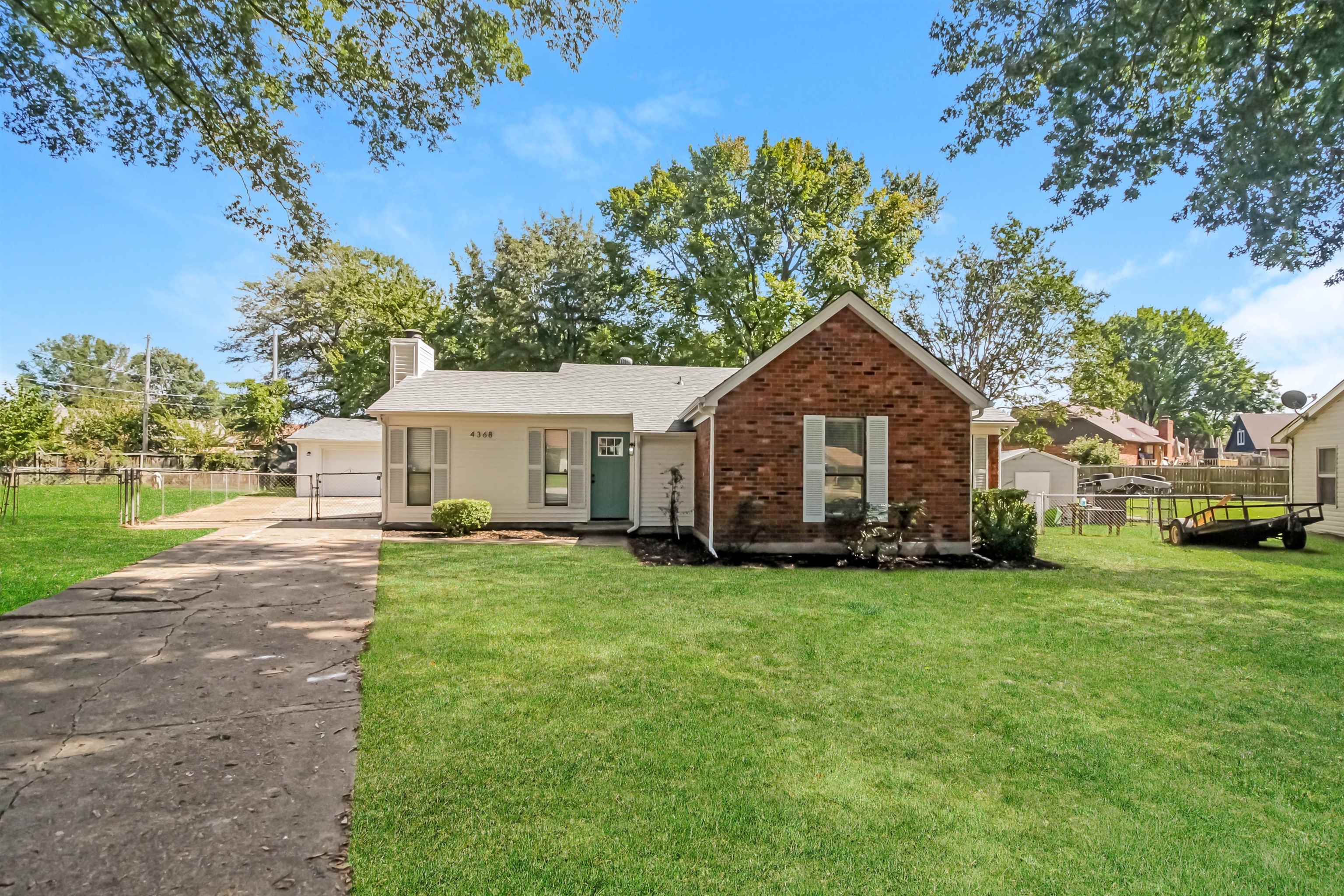 a front view of a house with yard porch and green space