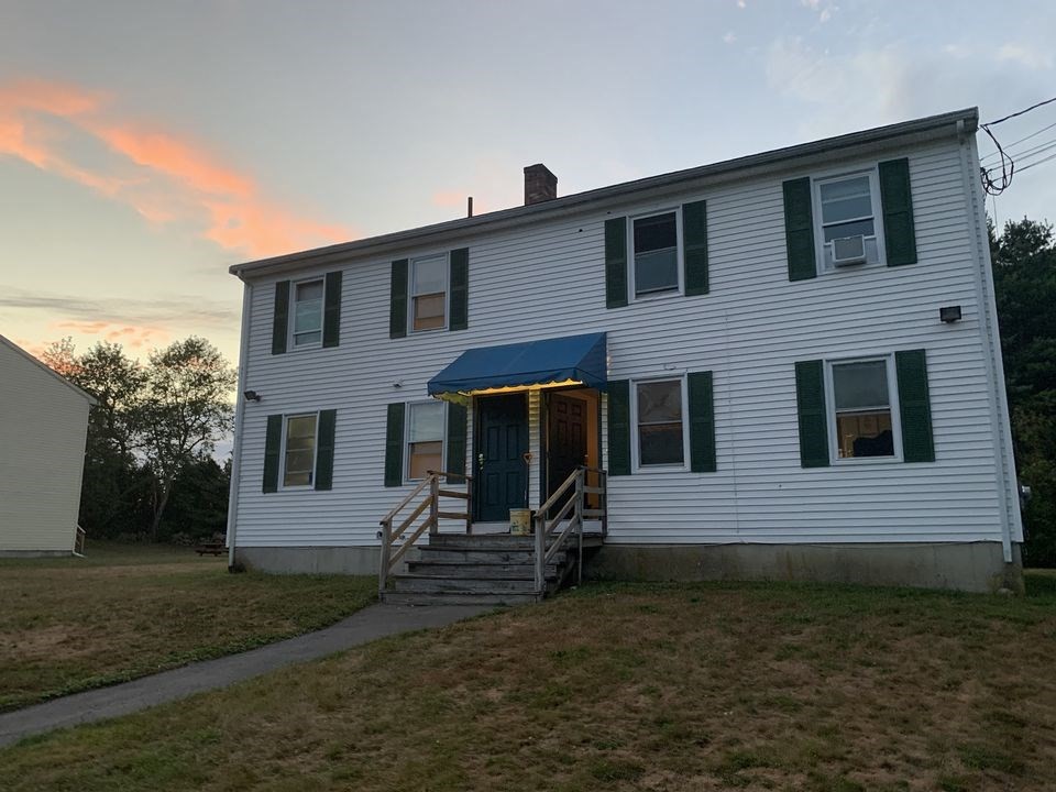 a view of house with backyard