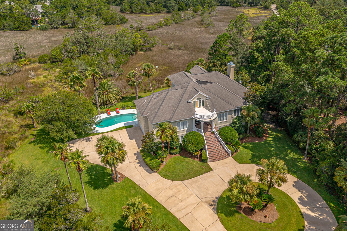 an aerial view of a house with yard swimming pool and outdoor seating