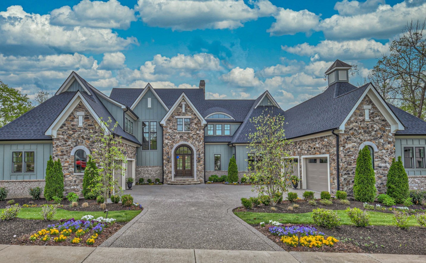 a front view of a house with a garden