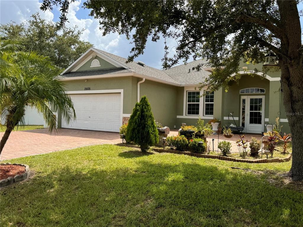 a front view of a house with a yard outdoor seating and garage