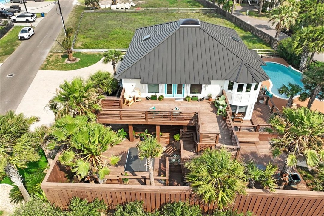 an aerial view of a house with garden space and sitting area