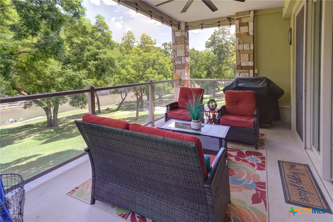 a view of a chairs and table in the balcony