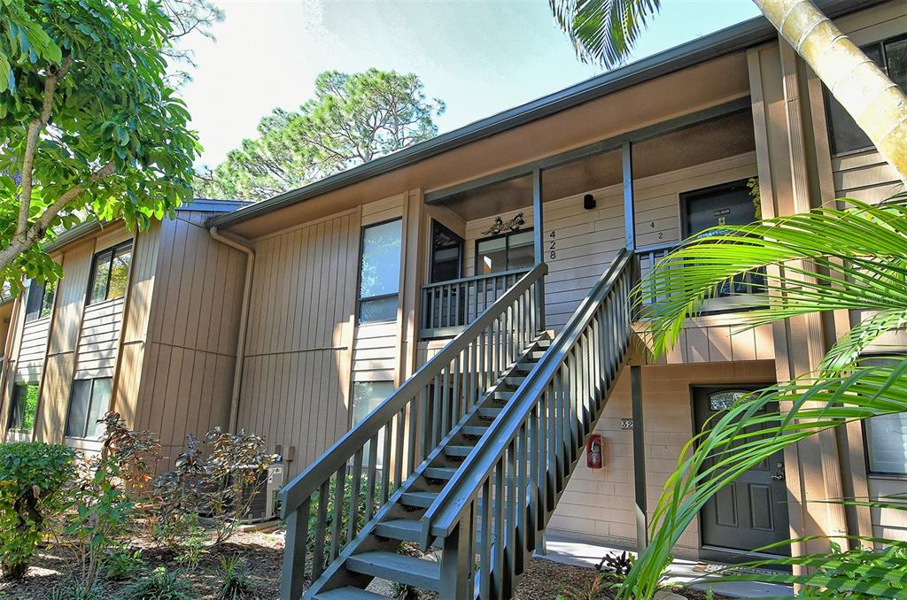 a front view of house along with deck and outdoor space