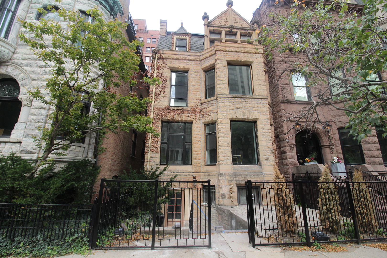 front view of a brick house with a small yard