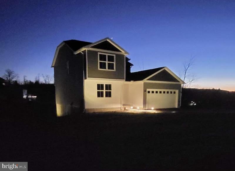 a view of a house with a yard and garage