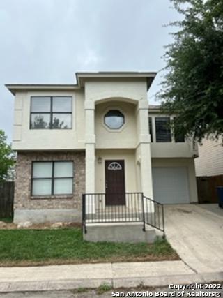 a front view of a house with garage