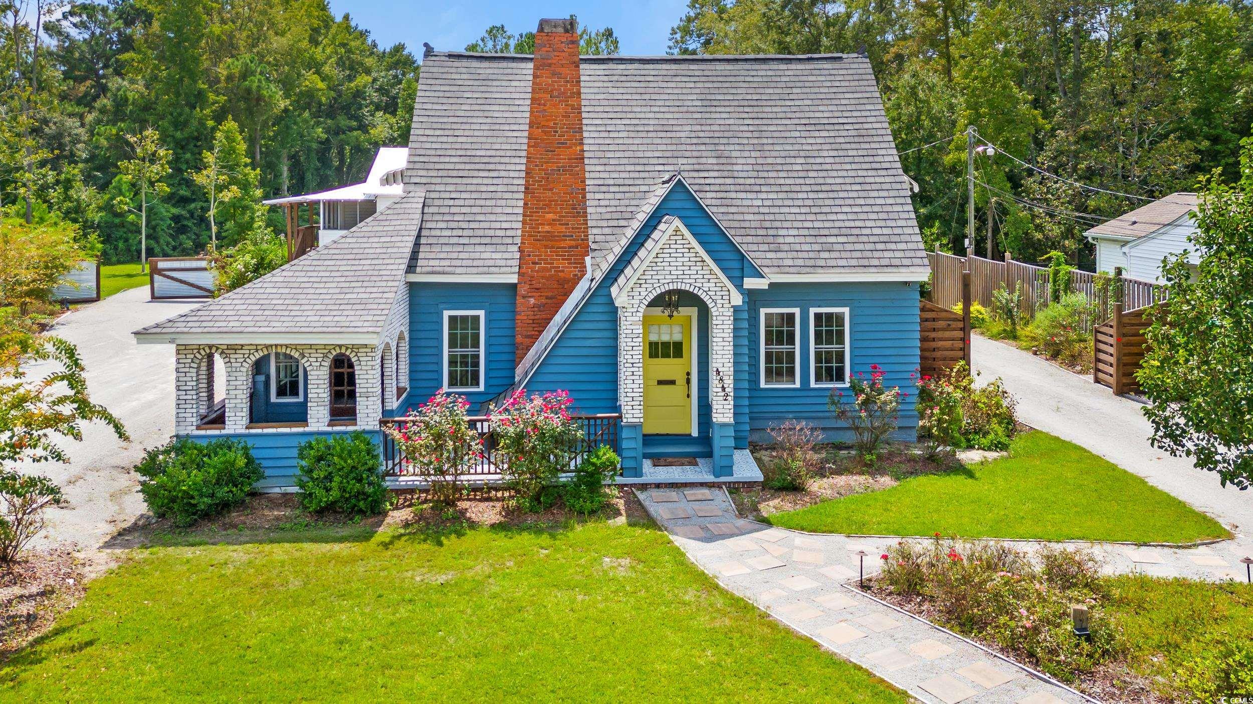 Tudor home with a front yard and a porch