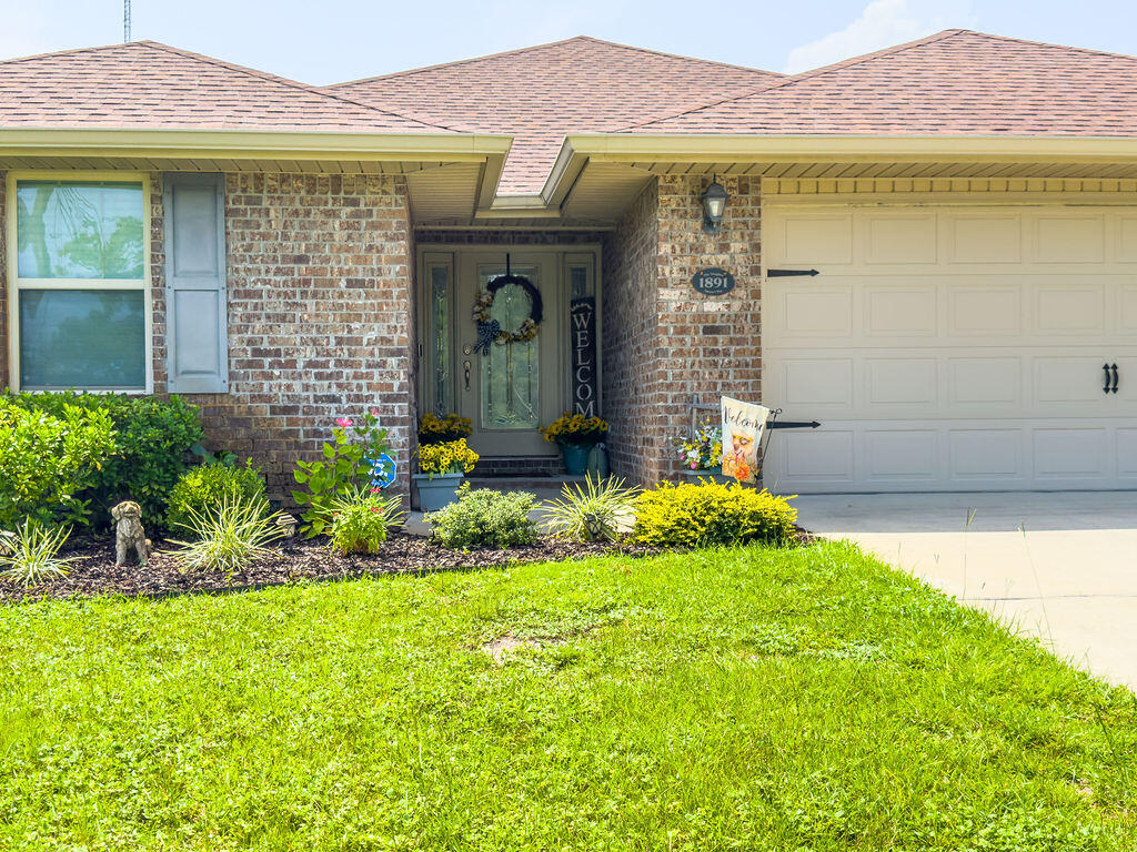 a front view of a house with garden