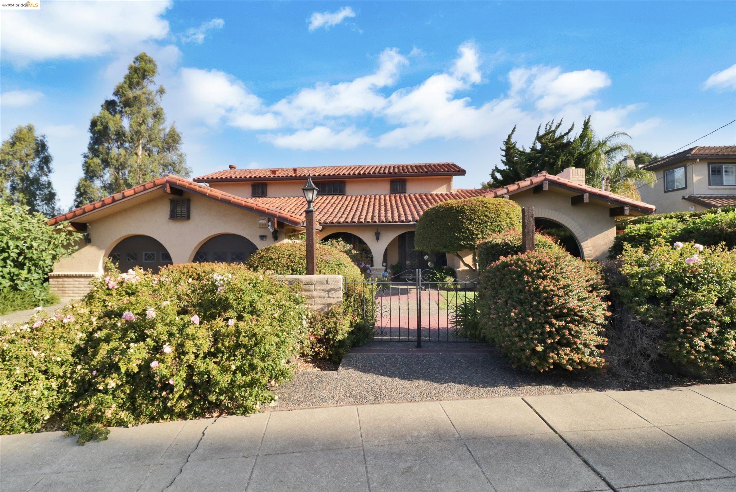 a front view of a house with garden