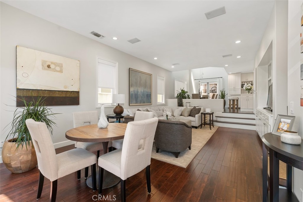 a living room with furniture a wooden floor and a sink