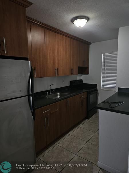 a kitchen with a sink and a refrigerator