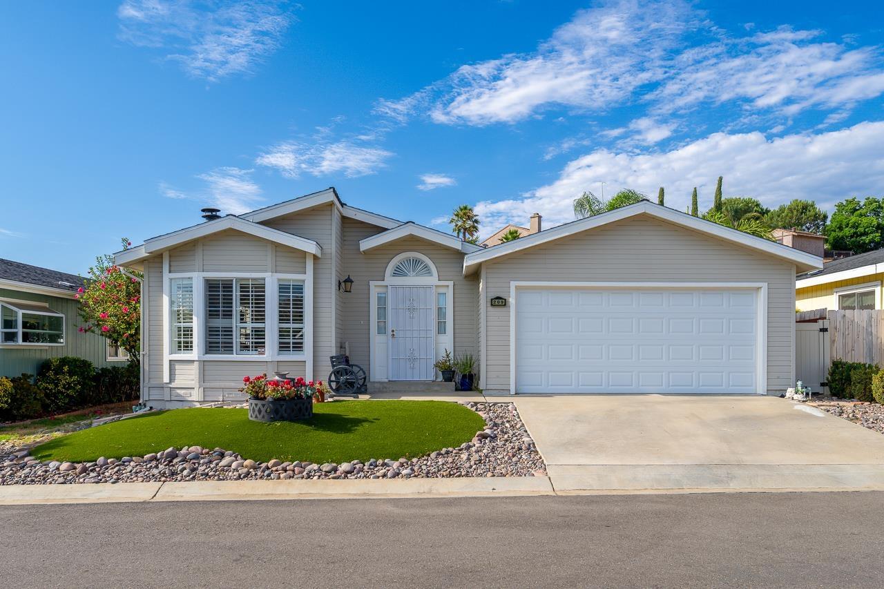 a front view of a house with a garden and yard