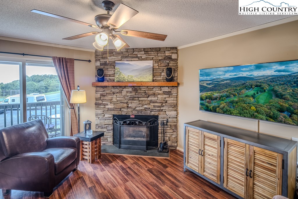 a living room with furniture a fireplace and a flat screen tv