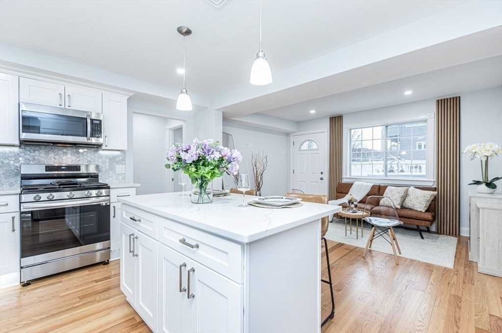 a kitchen with a stove and a white cabinets