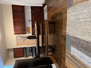 a view of kitchen with a sink and a refrigerator