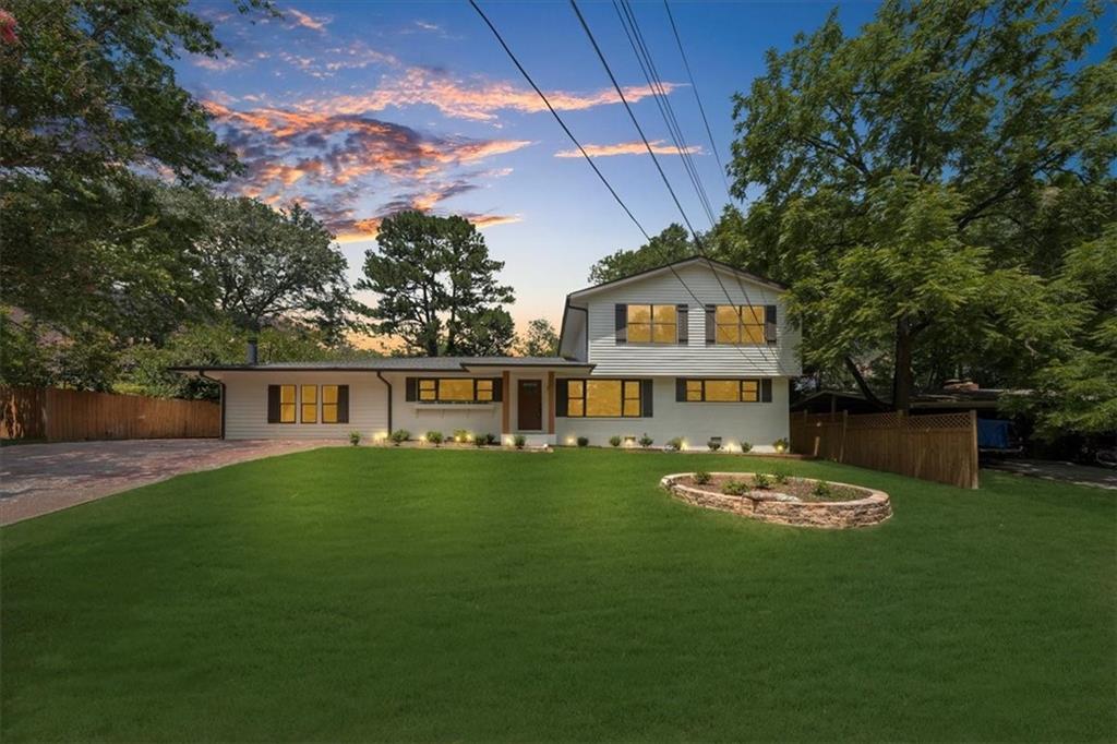 a front view of a house with a garden