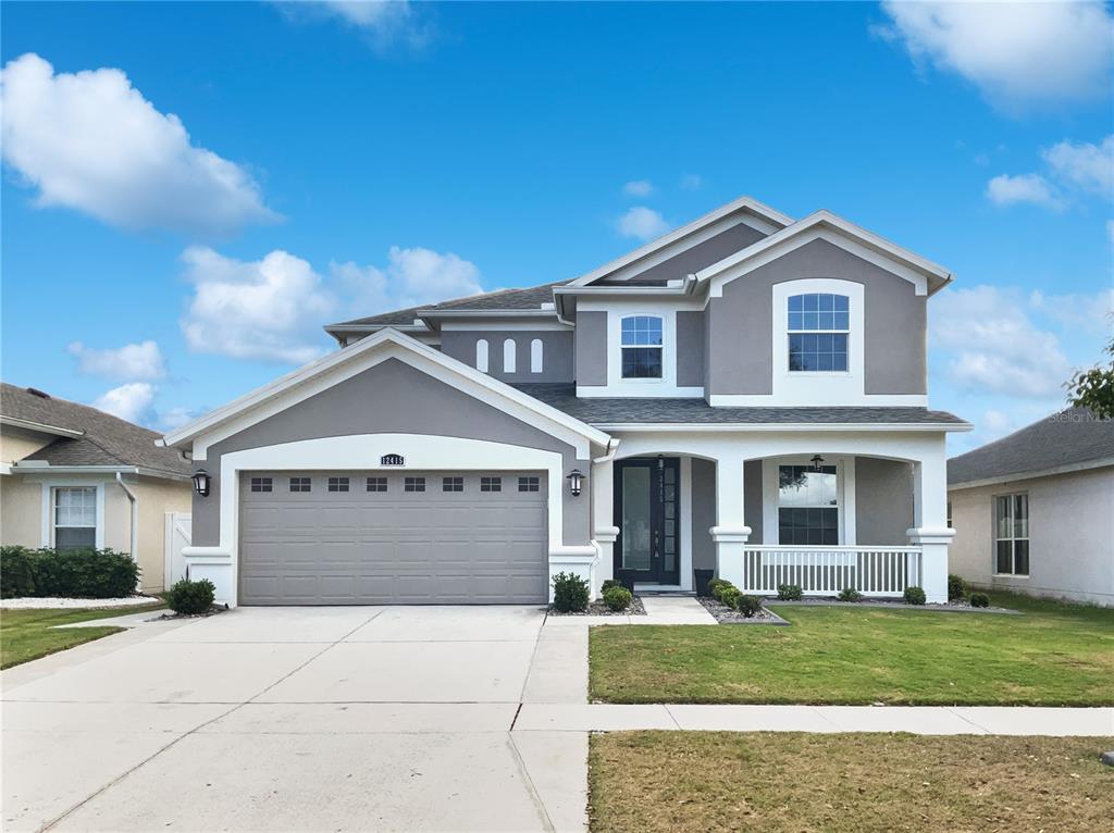 a front view of a house with a yard and garage