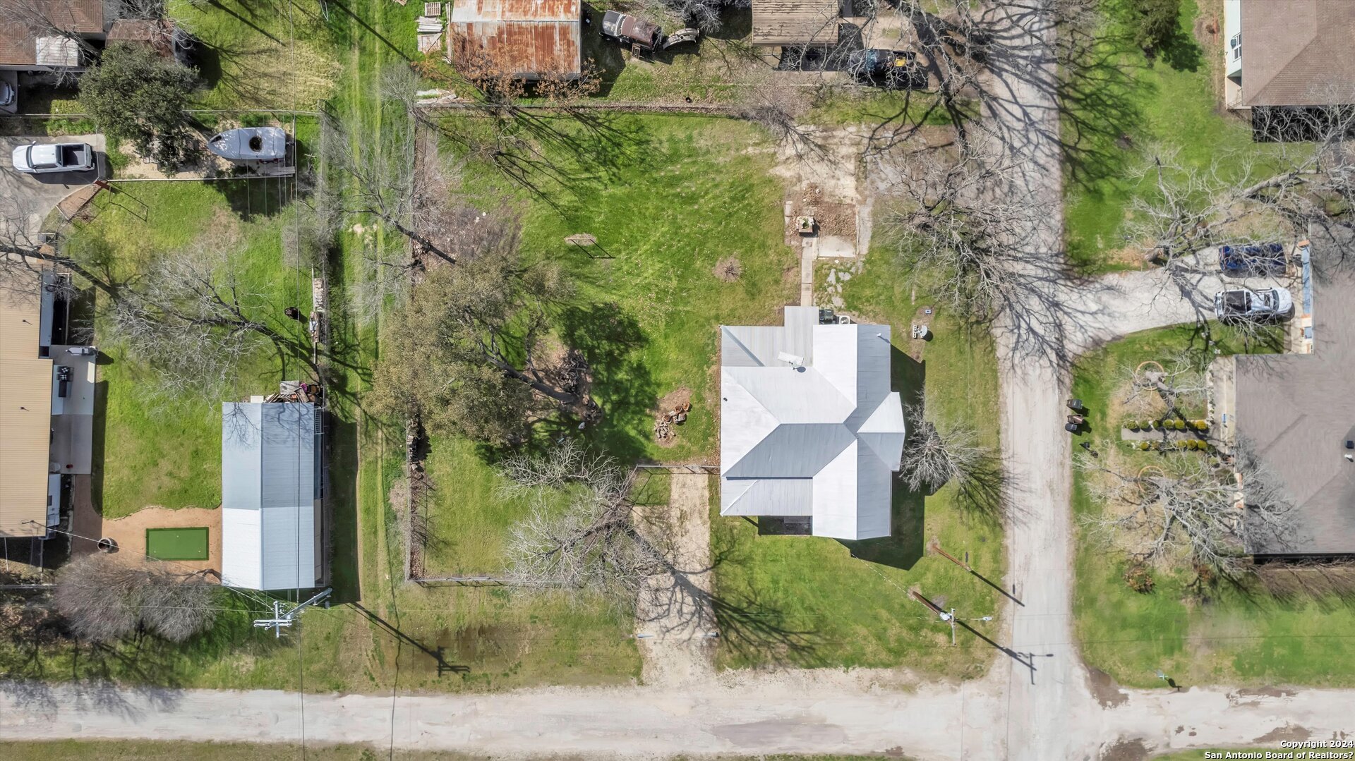 an aerial view of residential houses with outdoor space