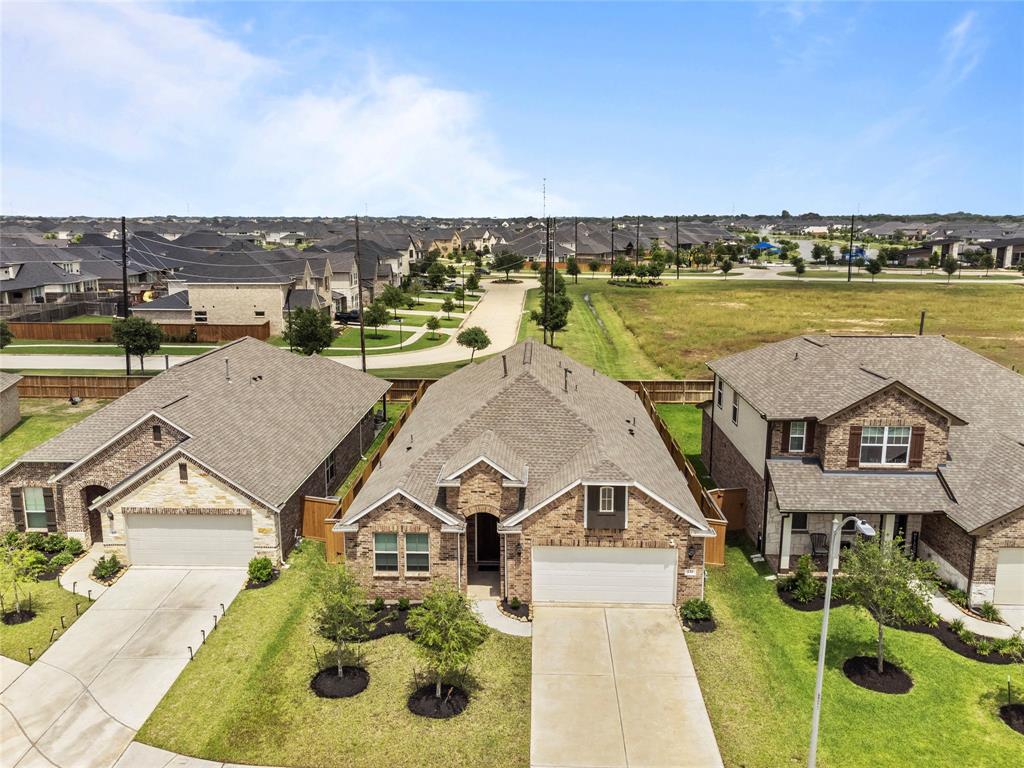 an aerial view of residential houses with outdoor space and ocean