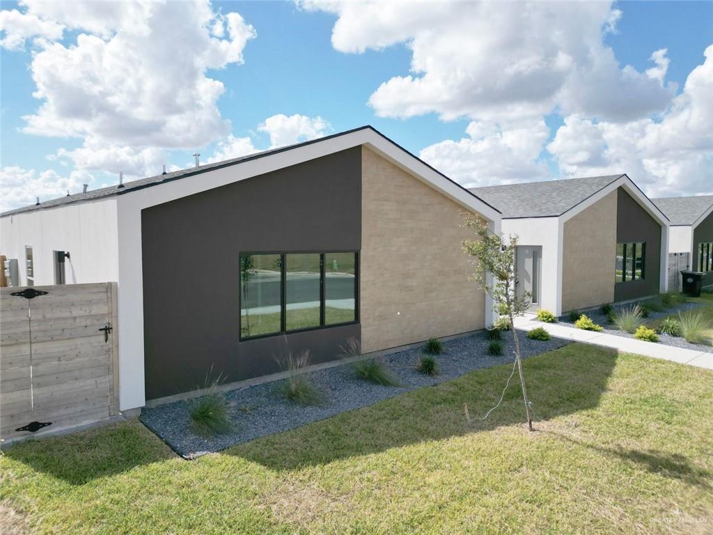 View of side of home featuring a yard