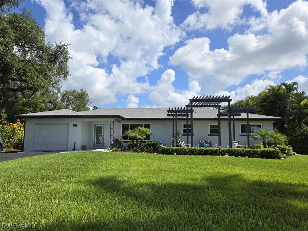 a front view of house with yard and green space