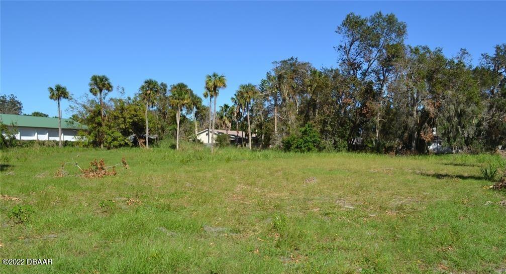 a view of a field of grass and trees